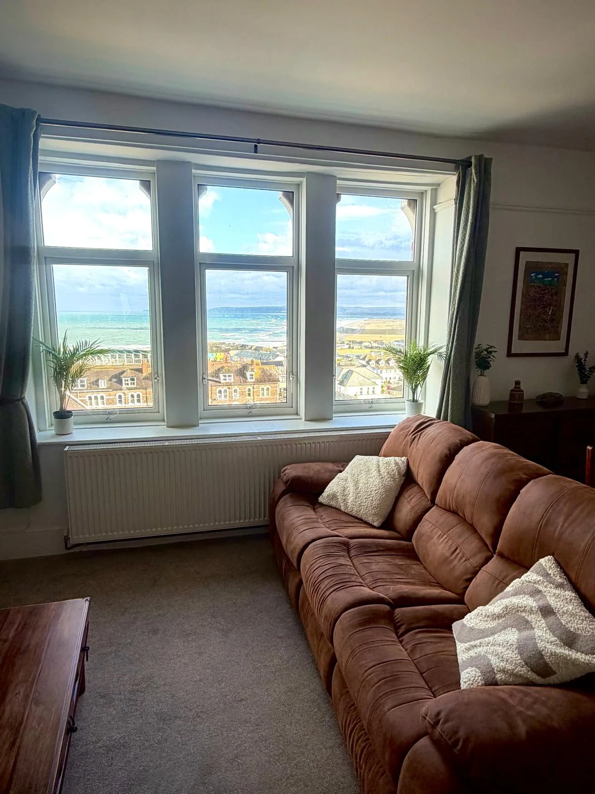 Comfortable living room with a large window overlooking Westward Ho! beach and coastline