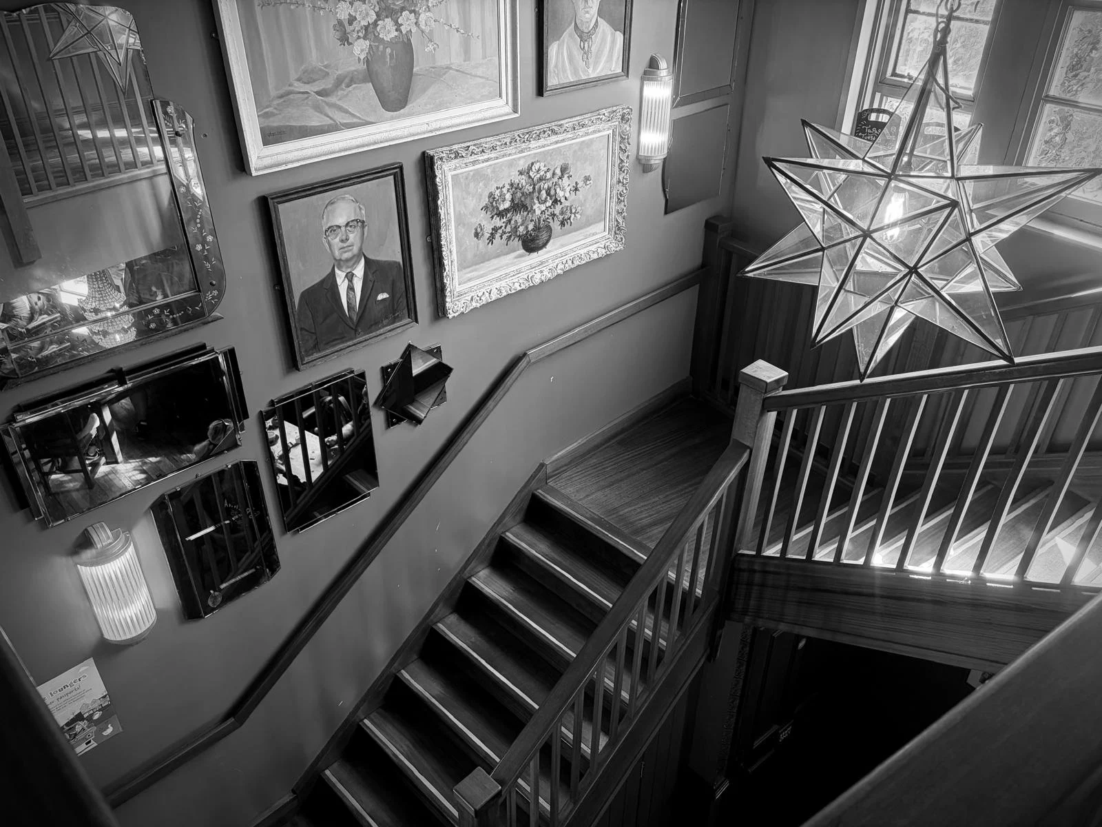 Framed cinema photographs lining the stairs inside Teatro Lounge