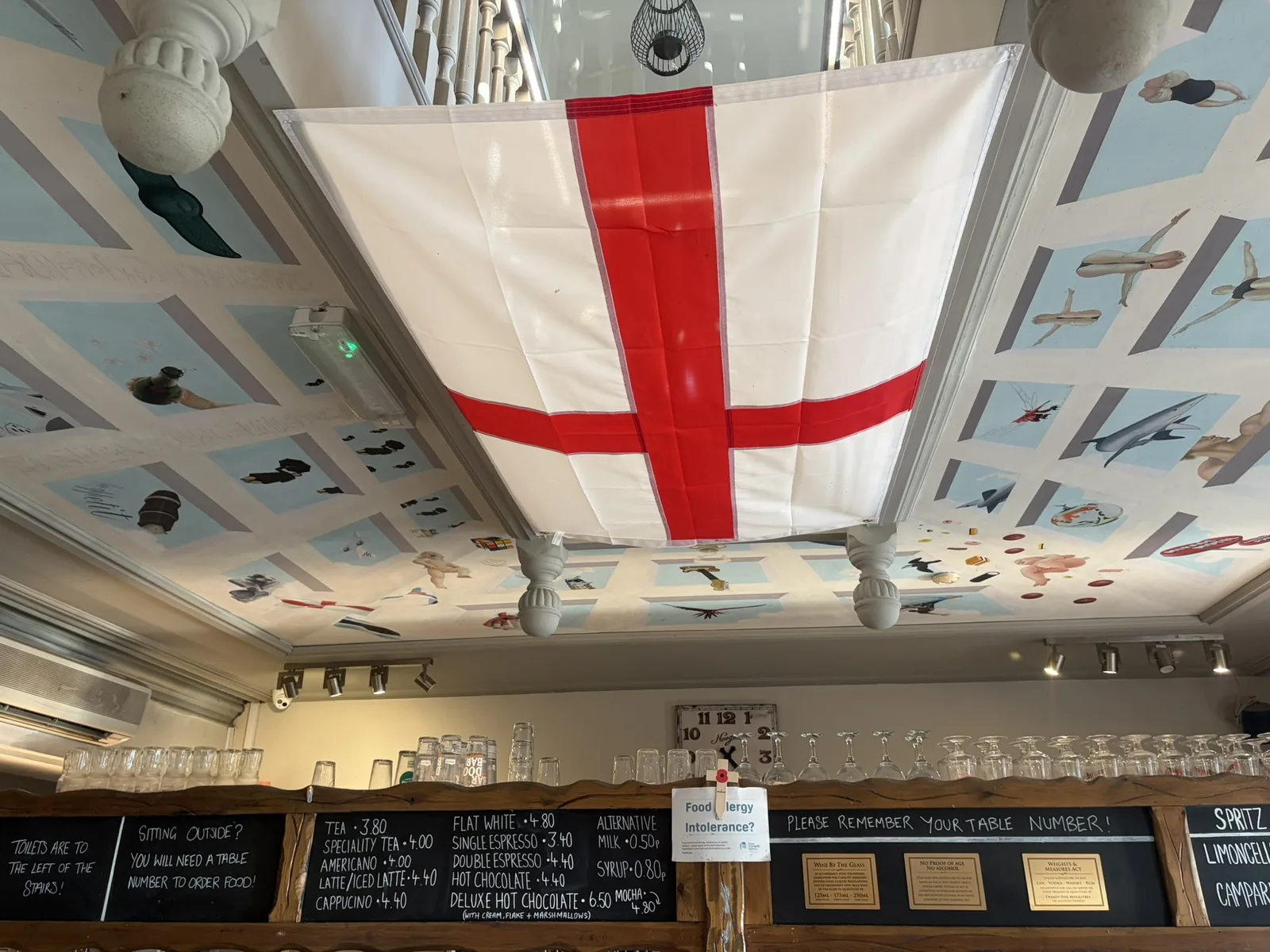 Interior bar at The Instow Arms beneath a large St George’s flag