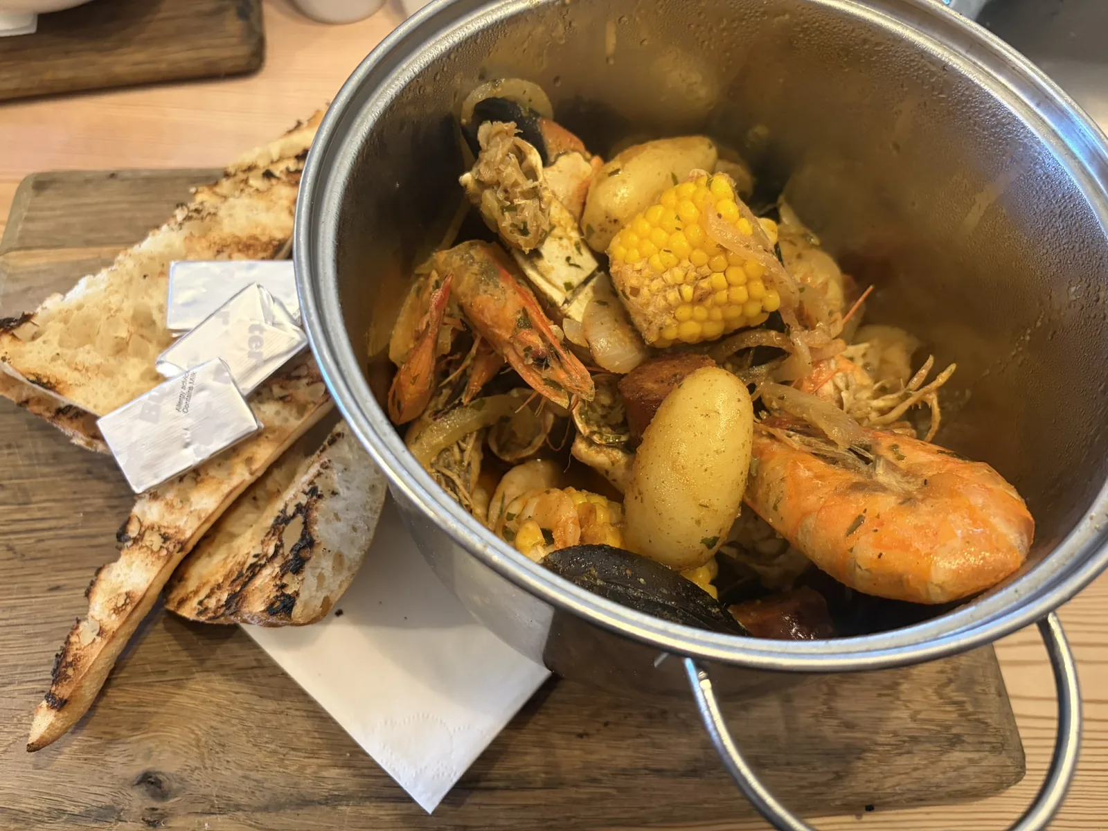 Seafood boil with shellfish, potatoes, corn and bread at The Instow Arms