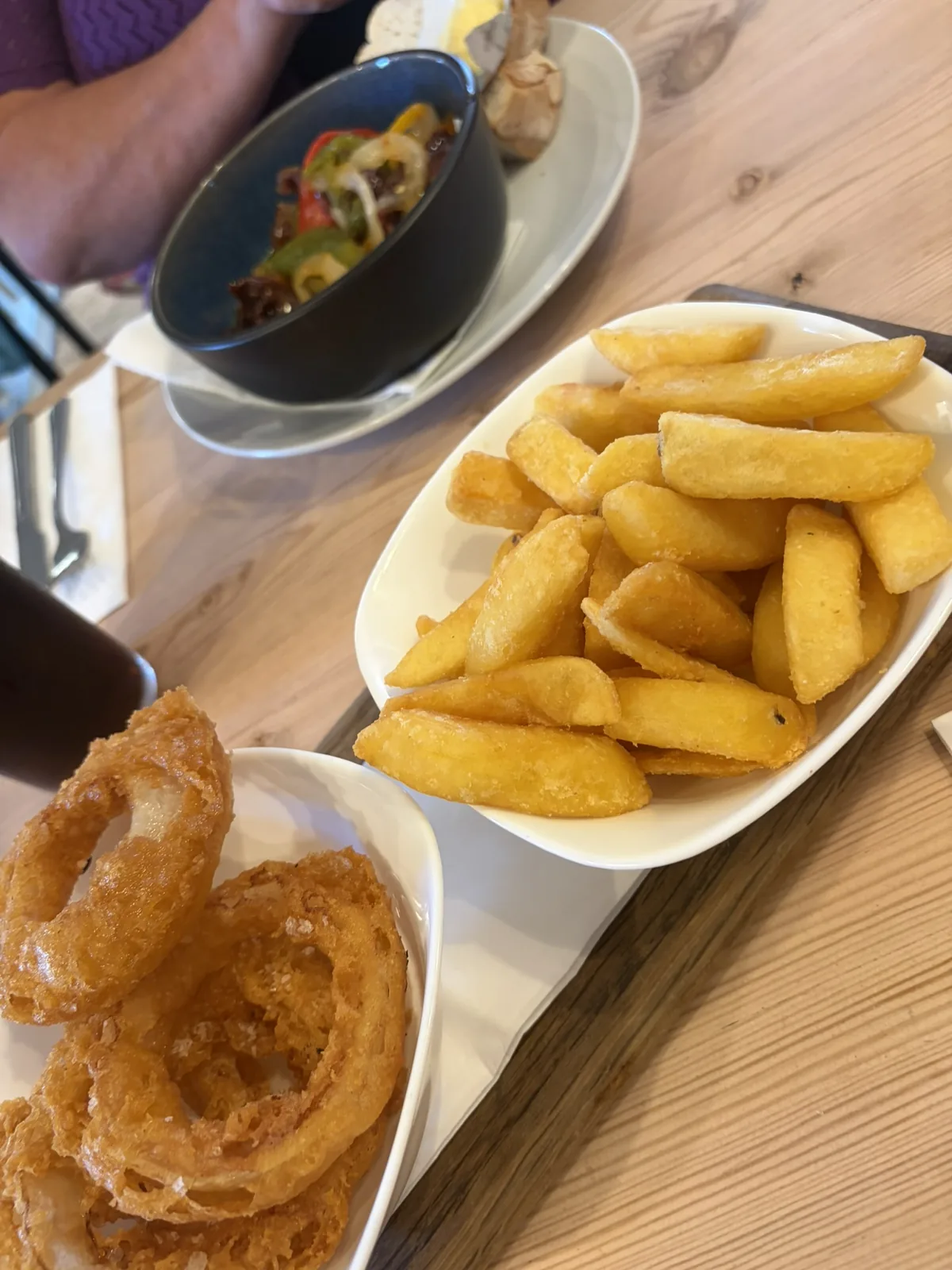 Onion rings, chips and side dishes on a table at The Instow Arms