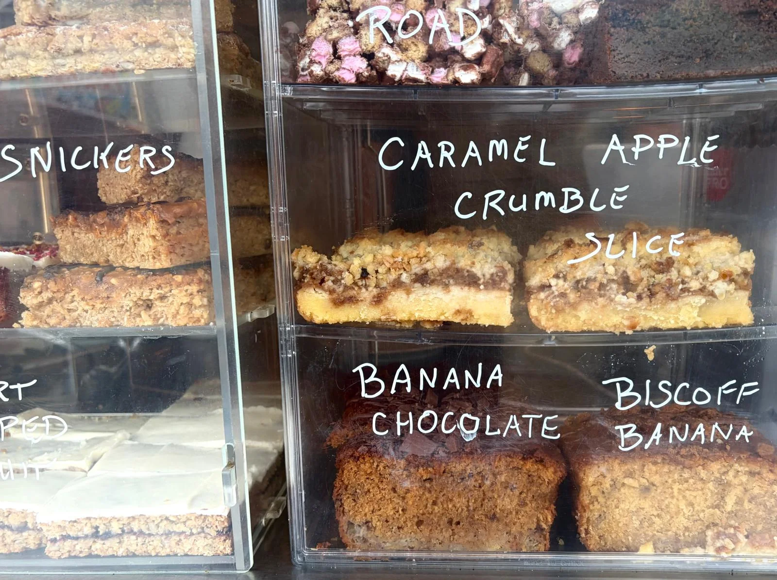 Selection of cakes and traybakes in the display at Cabana
