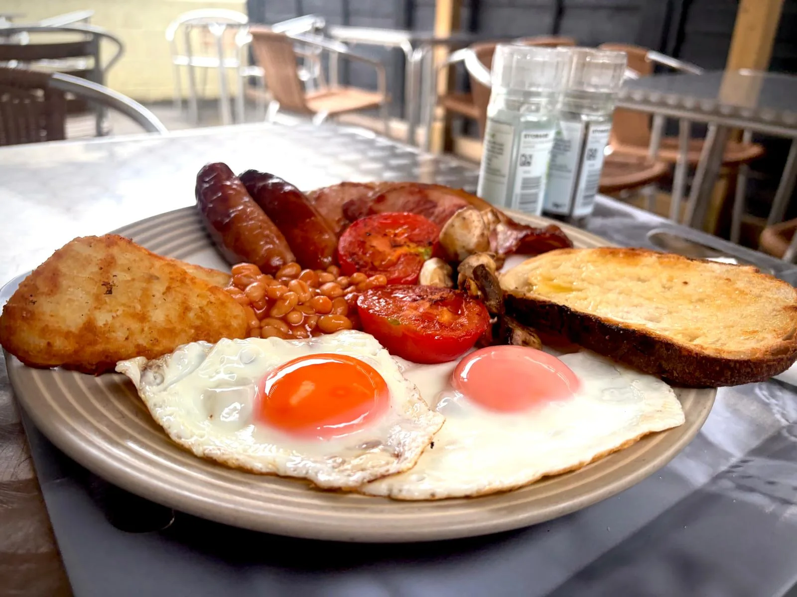 Full English breakfast with eggs, sausages, bacon, hash brown, beans, tomatoes, mushrooms and sourdough toast at Cabana