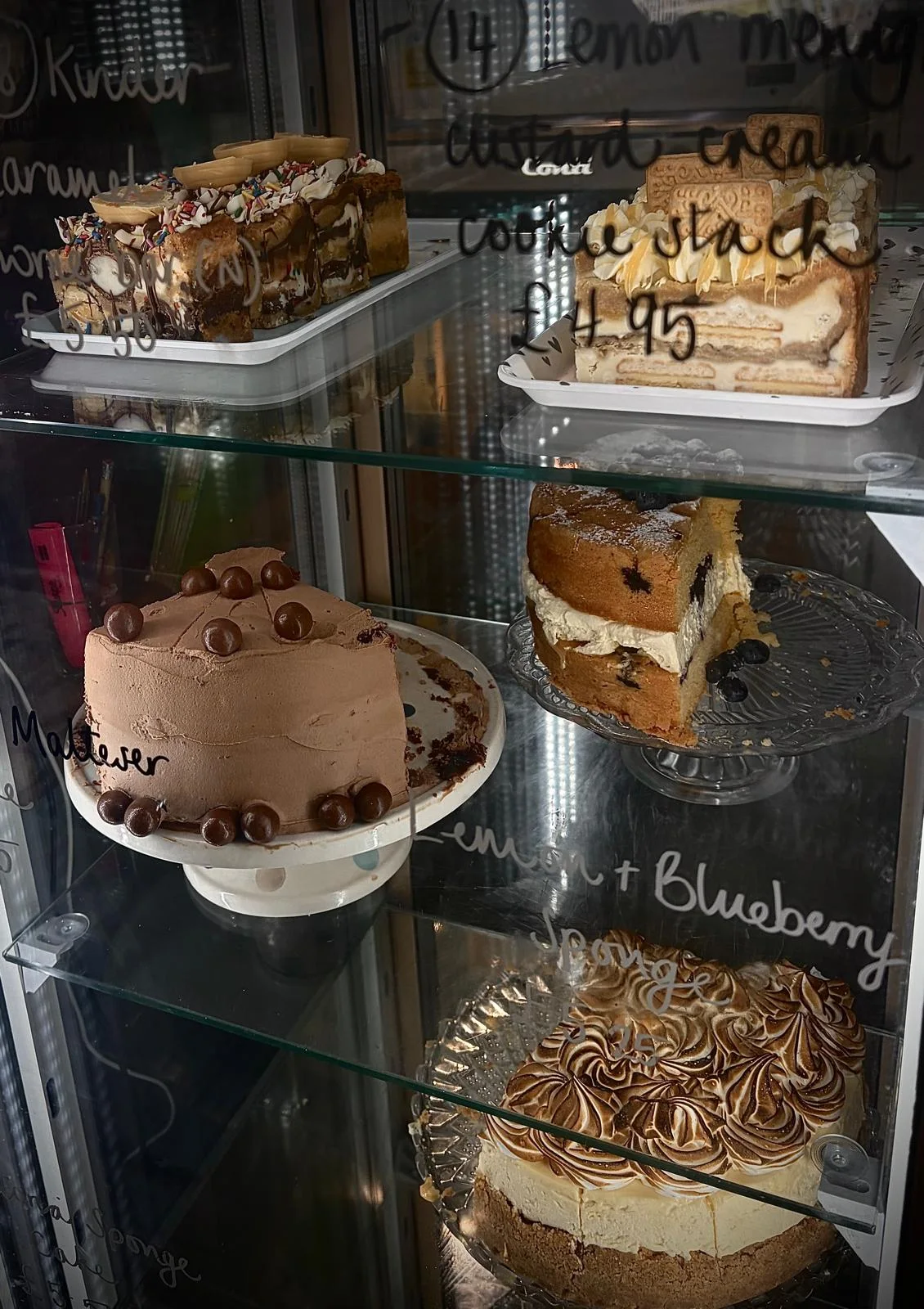Large homemade cakes inside the Tea on the Green cake cabinet