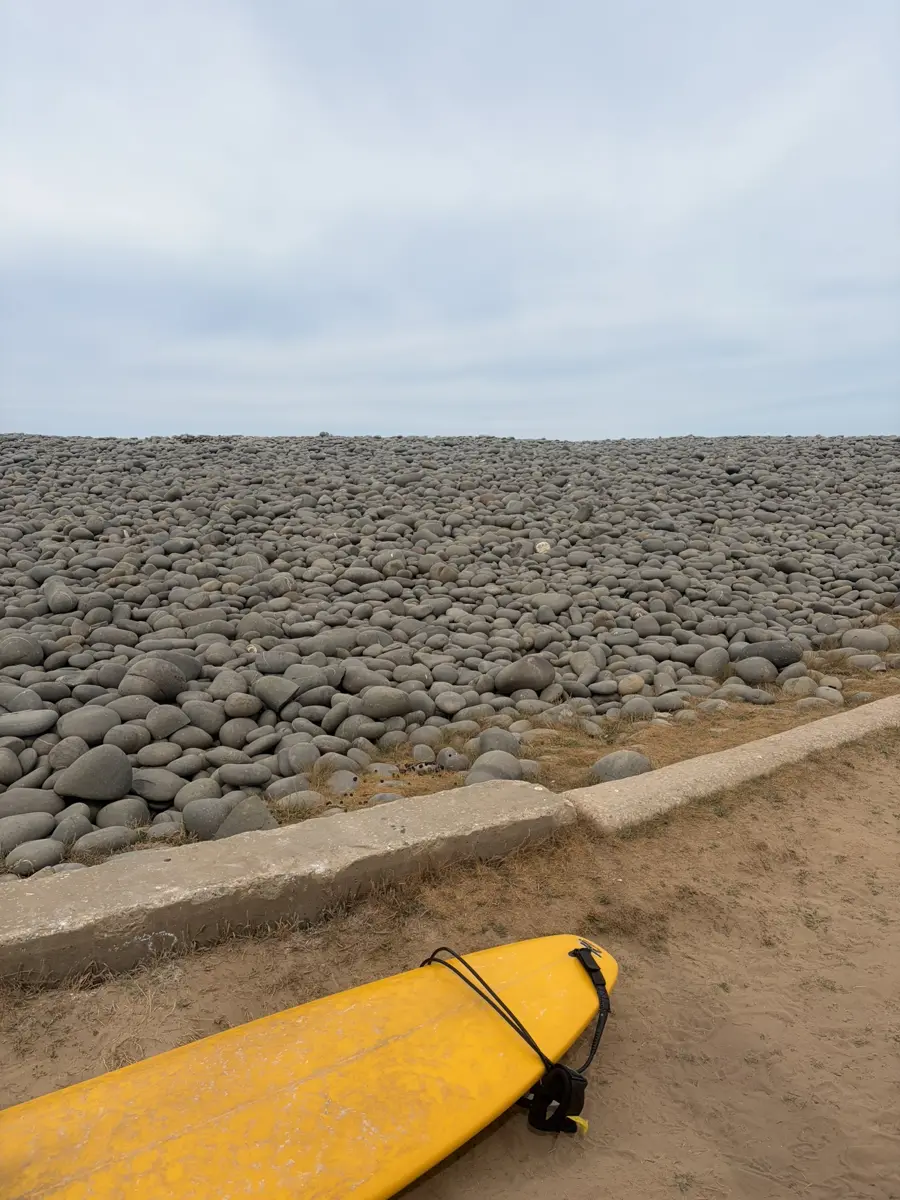 The Pebble Ridge at Westward Ho!, with a surfboard on the path