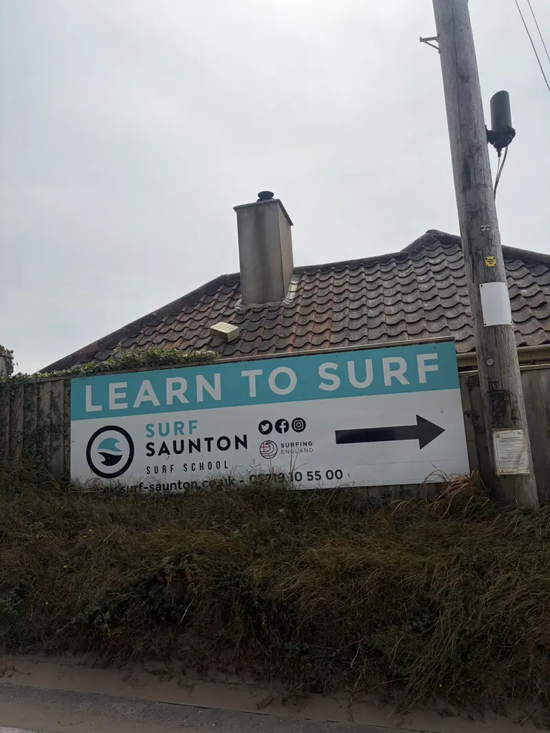 Surf Saunton's Learn to Surf sign on the road to the beach