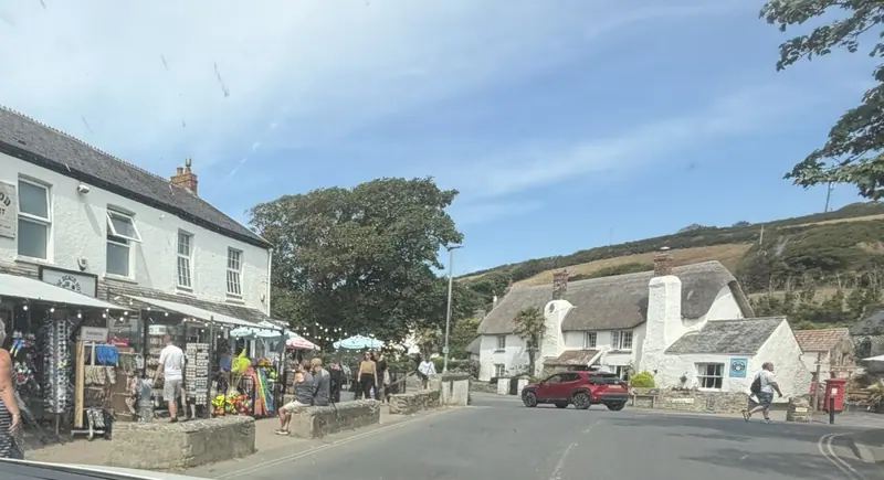 Shops and thatched cottages on the main street in Croyde village