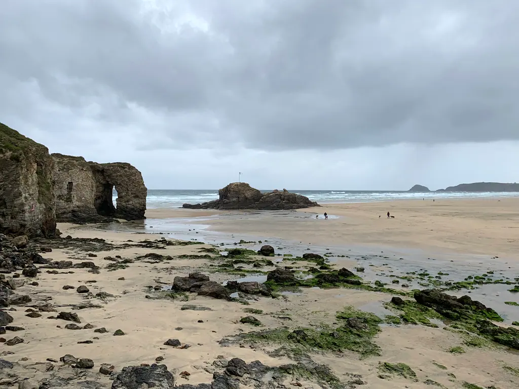 Perranporth beach at low tide with the rock arch and Chapel Rock area