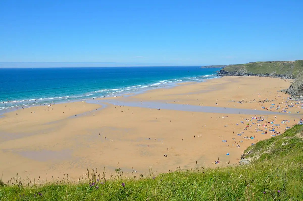 The long beach at Watergate Bay seen from the clifftop on a bright day